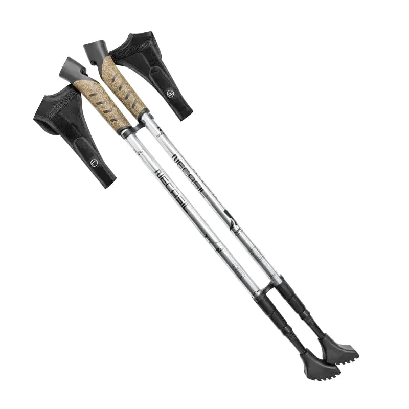 Silver and black trekking poles with textured tan grip handles