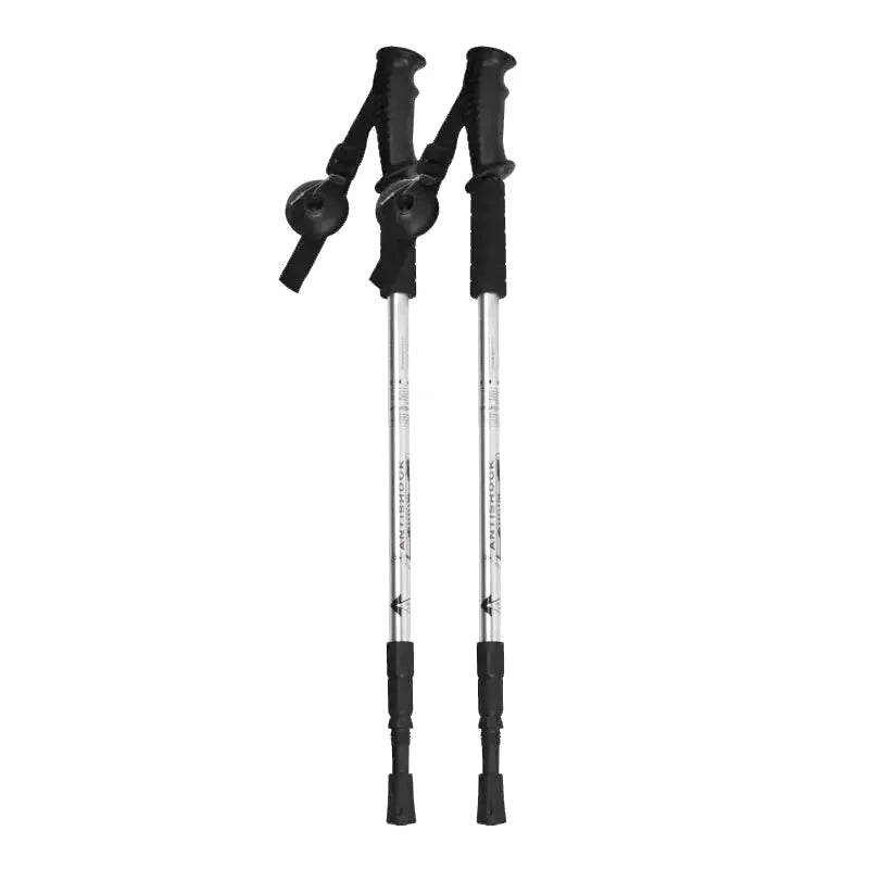 A pair of black and silver adjustable trekking poles with ergonomic grips