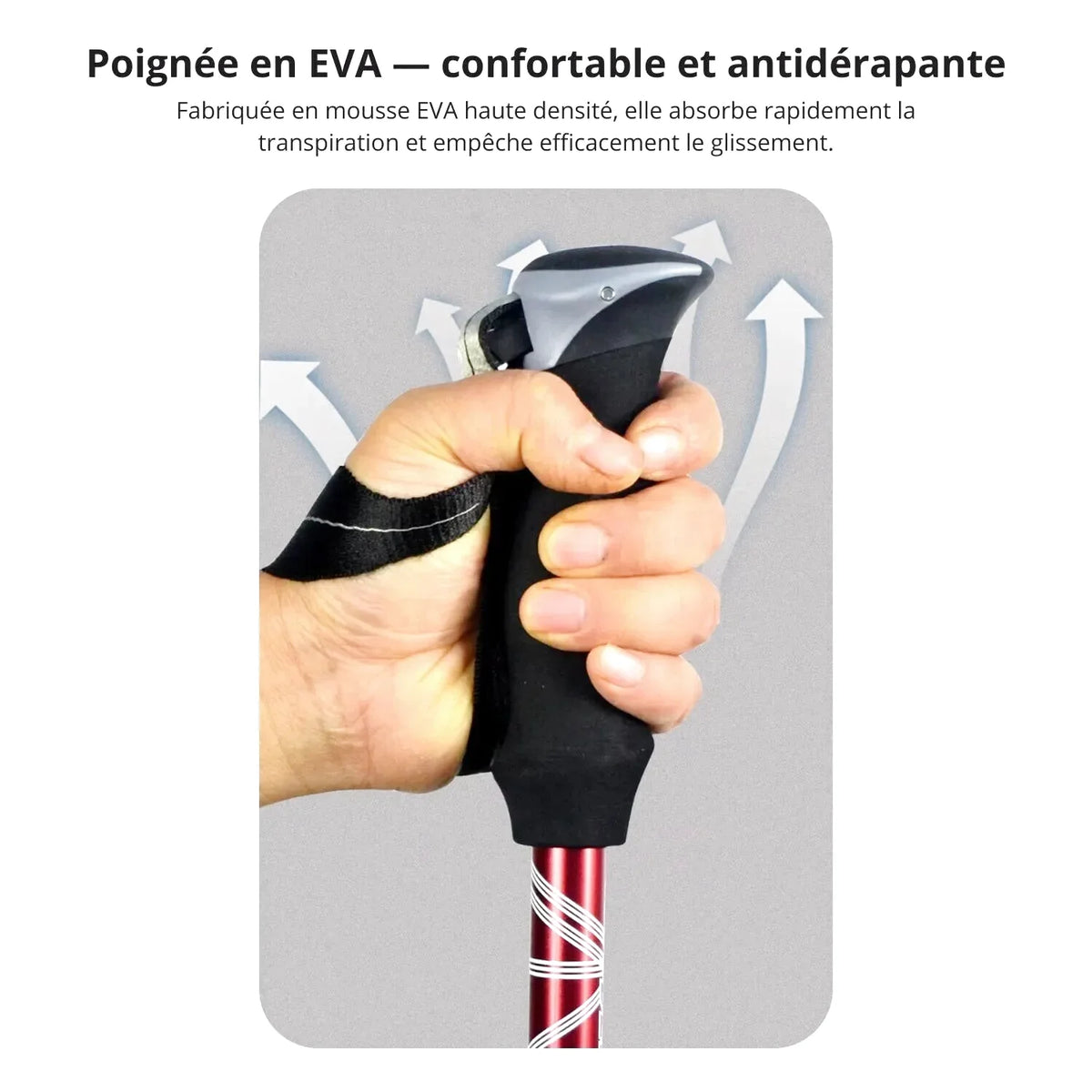 Black and silver eva grip handle on a red hiking pole with white spiral patterns
