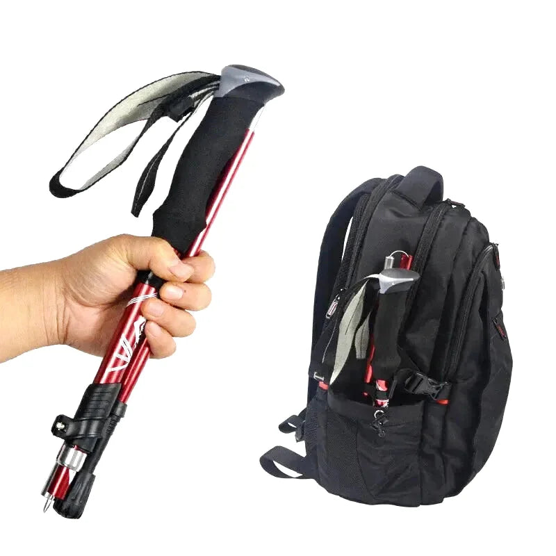 Red and black collapsible hiking pole with a textured grip