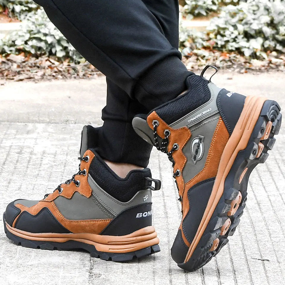 Brown and gray high-top hiking boots with black laces, suede and synthetic overlays, and a rugged rubber sole