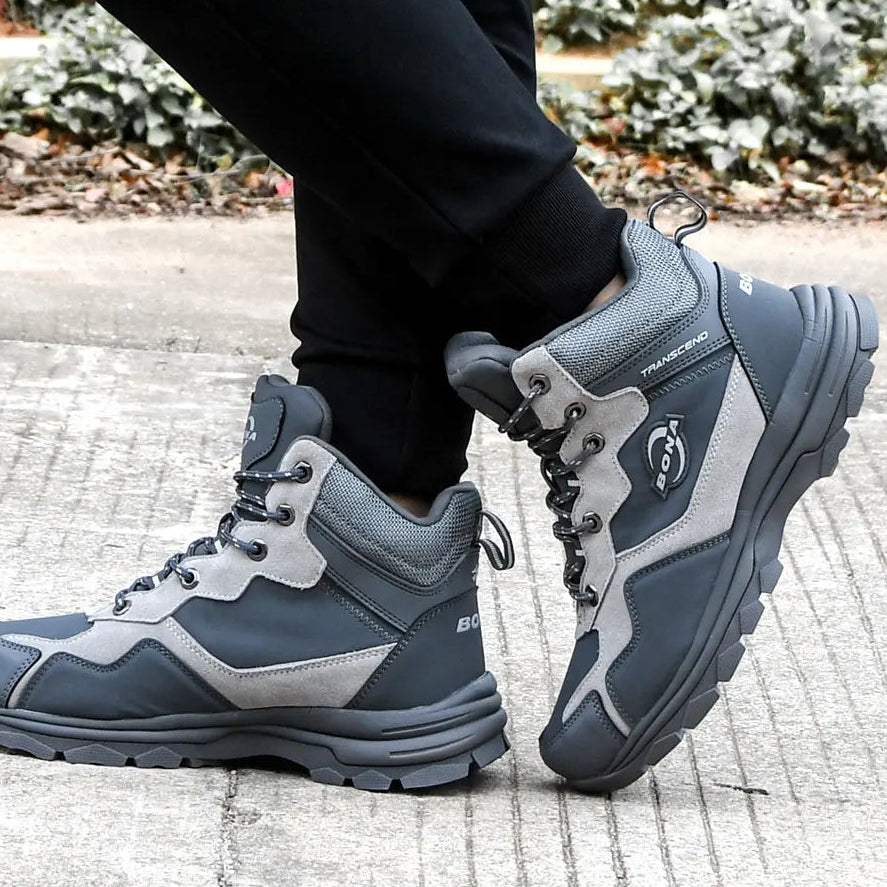 Dark gray and light gray high-top hiking boots with a rugged, textured sole and reinforced stitching