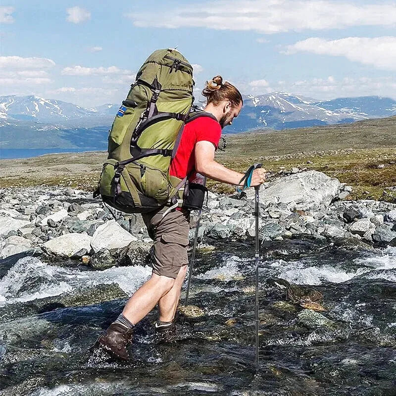 Olive green hiking backpack with black straps and reinforced stitching, designed for rugged outdoor use