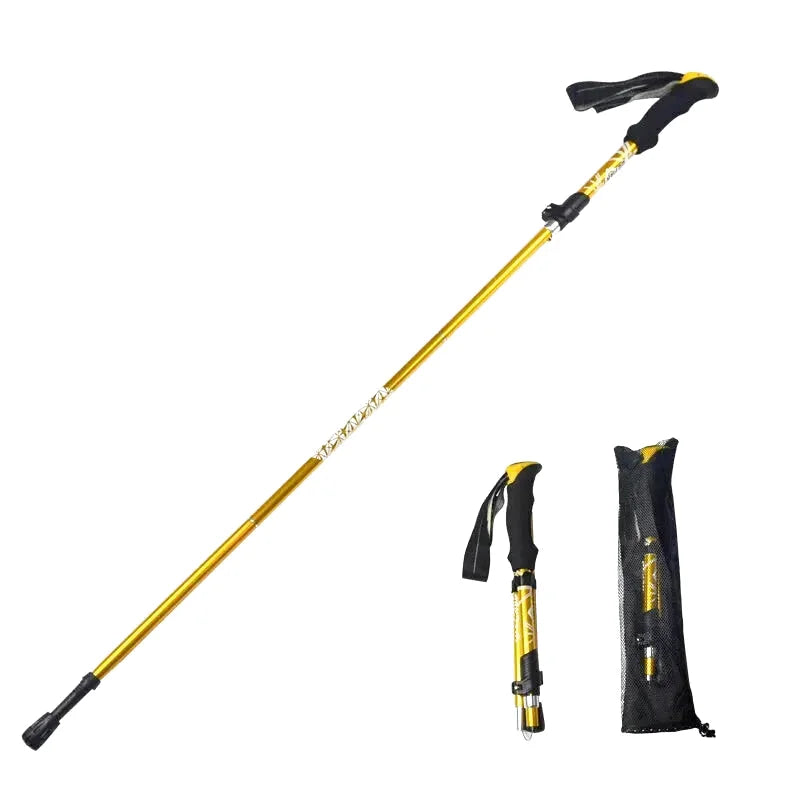Gold-colored telescopic hiking pole with black ergonomic grip and adjustable sections, shown alongside its folded version and carrying pouch